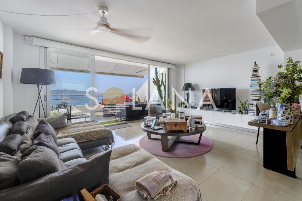 Living room with sofa opening onto sea-view terrace