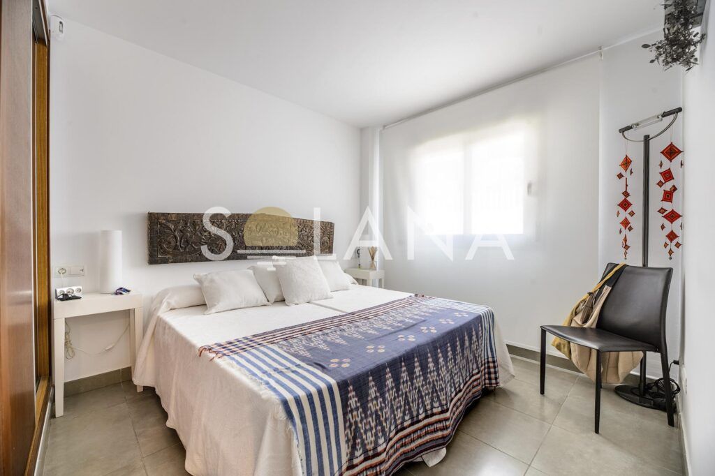 Bright bedroom with window and built-in storage