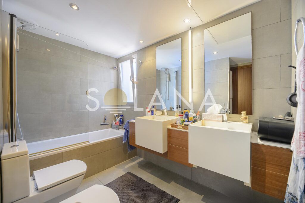 Bathroom with bathtub, vanity and window