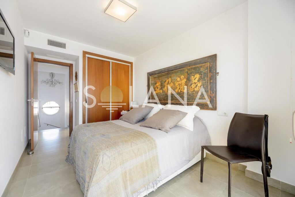 Guest bedroom with wardrobe and warm lighting