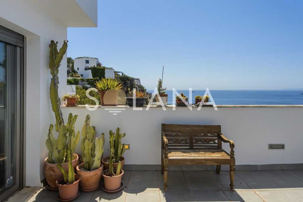Terrace bench with potted plants and sea views